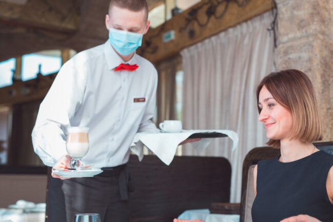 Restaurant server wearing mask