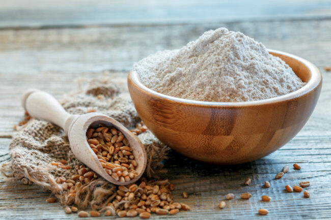 Whole wheat flour in a bowl and scoop