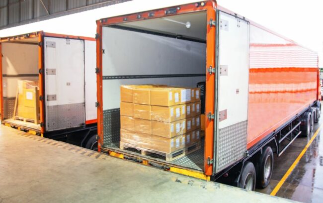 Freight trucks being loaded with boxes