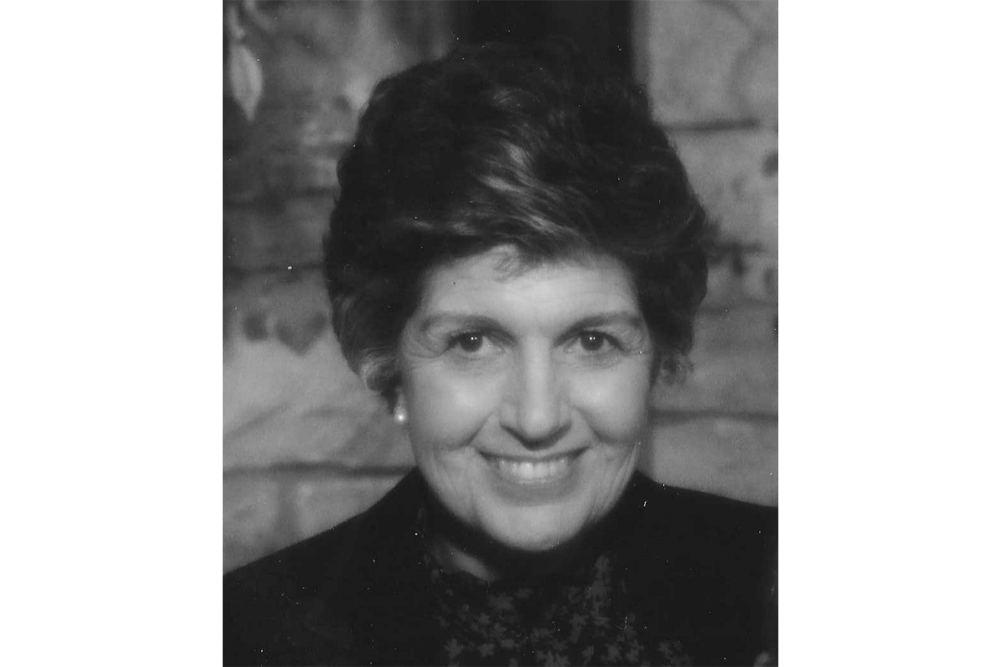 Joyce Hale smiles for the camera in a black and white photograph.