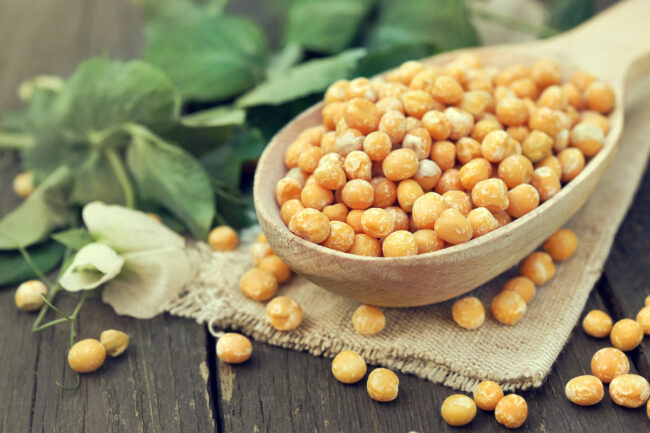 Chick peas on a wooden spoon.