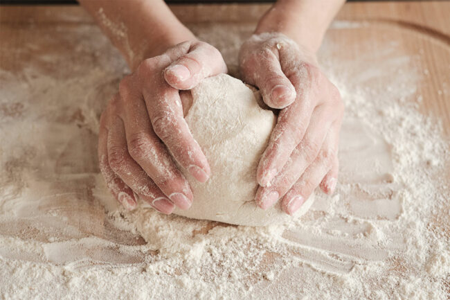 Hands making bread from scratch. 