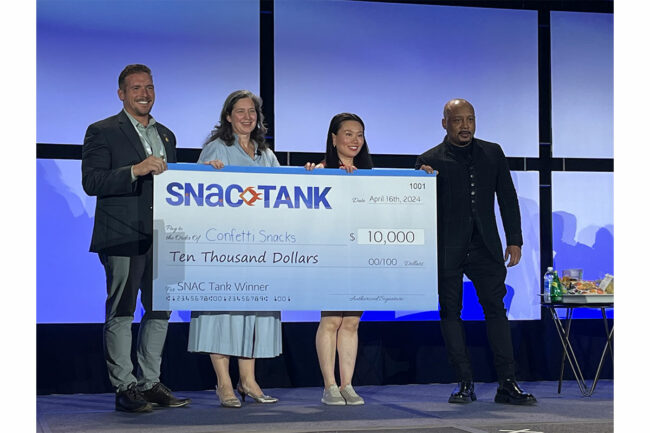 Justin Spannuth, Christine Cochran and Daymond John stand with SNAC Tank champion, Betty Lu. 