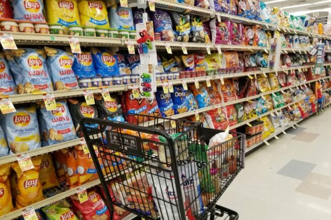 Assortment of chips and salty snacks in the grocery store.