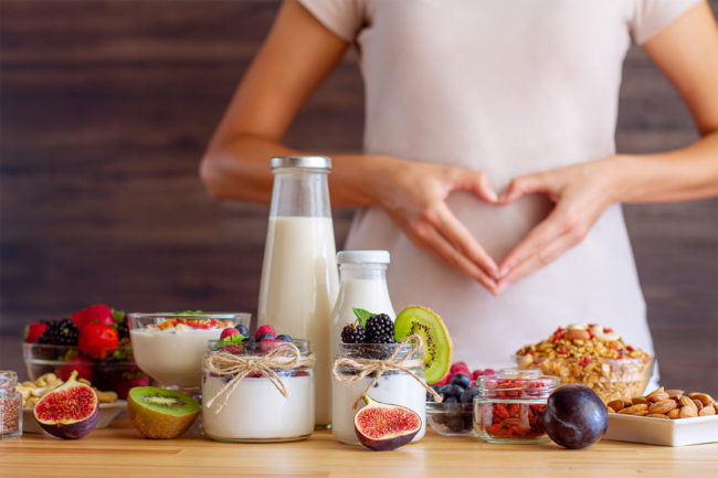 Woman with assortment of clean and healthy foods. 