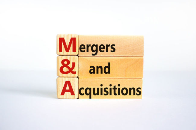 Mergers & acquisitions written out on wooden blocks. 