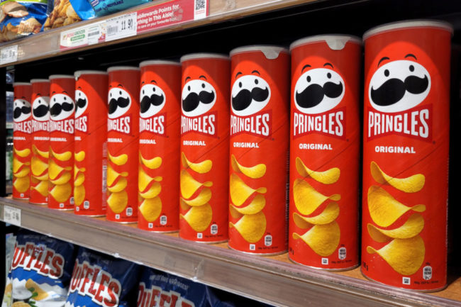 Pringles and other Kellanova products on grocery store shelf. 