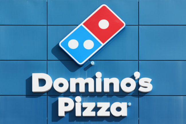 Domino's Pizza logo outside storefront. 