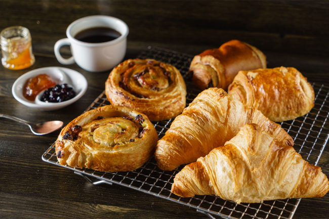 Assortment of French pastries with a cup of black coffee. 