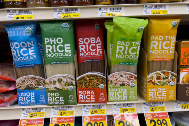 Assortment of noodle products at grocery store. 