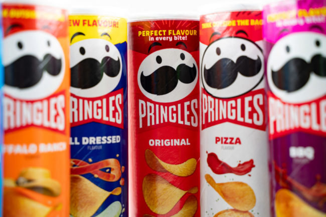 Assortment of different flavors of Pringles cans.