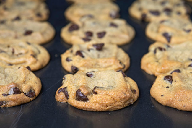 Chocolate chip cookies on baking line. 