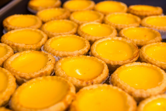 Plate of tart pastries with yellow icing. 