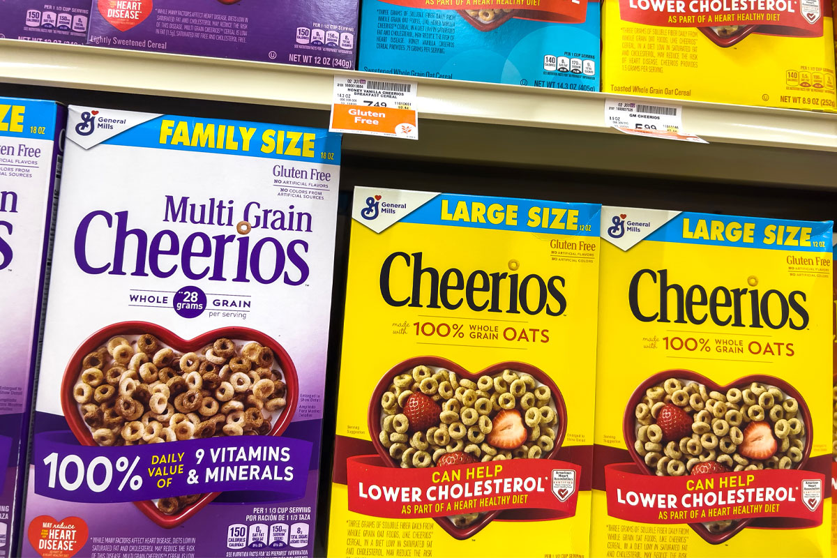 Boxes of Cheerios on grocery store shelf.