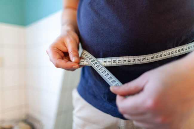 Man measuring weight. 