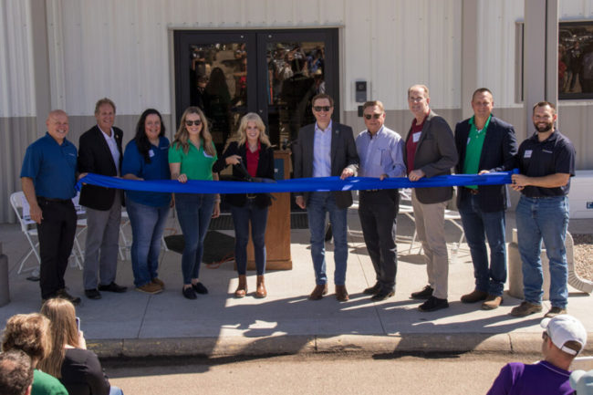 Employees of Scoular cut ribbon at new facility. 