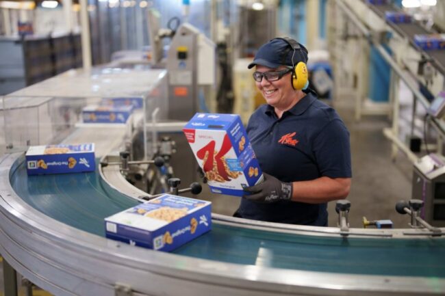 Employee on production line at Kellanova cereal plant. 