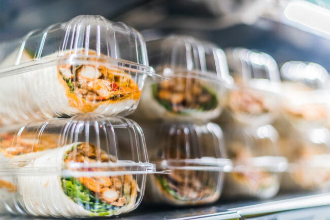 Assortment of sandwiches in grocery store fridge. 