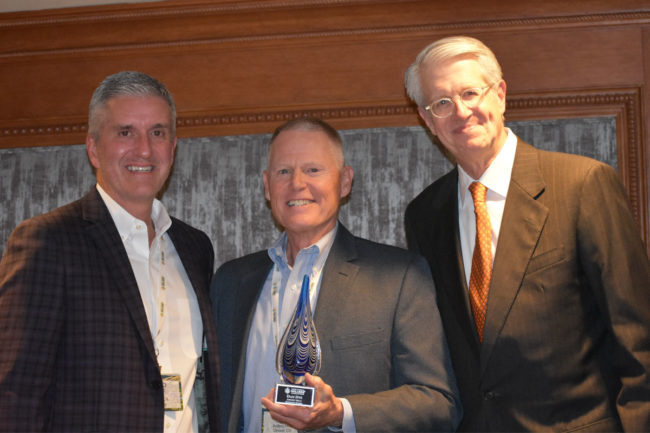 Dan Dye, center, was elected by NAMA as an honorary member at the group’s 2024 annual meeting. At an awards ceremony, he was introduced by L. Joshua Sosland, right, and presented with an award by Tedd Kruse, NAMA chair.