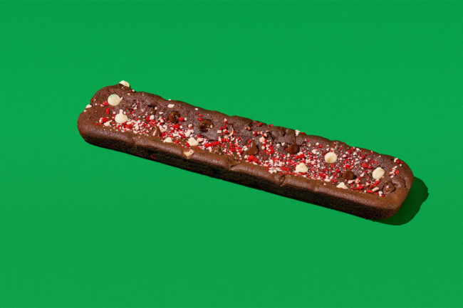 Footlong Subway double chocolate peppermint cookie on green background. 