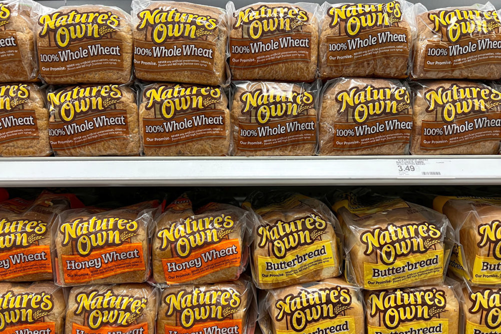 Loaves of Nature's Own bread on grocery store shelf. 