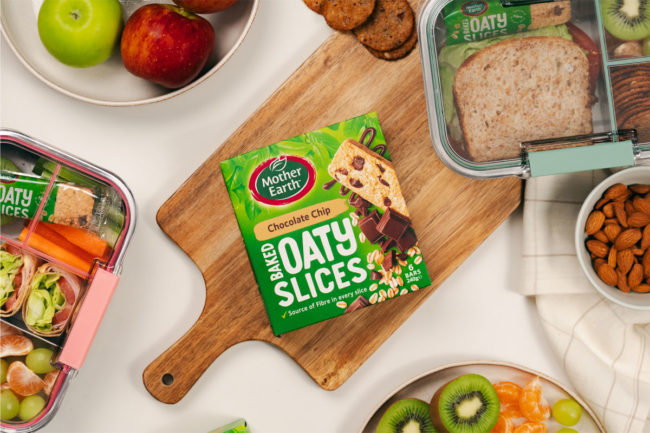 Box of Mother Earth Baked Oaty Slices with surrounding food products. 