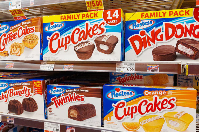 Assortment of Hostess products displayed on grocery store shelf. 