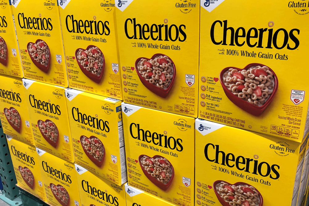 Boxes of Cheerios on grocery store shelf.