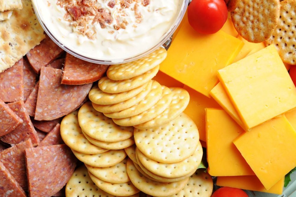 Board with meat, cheese and crackers. 