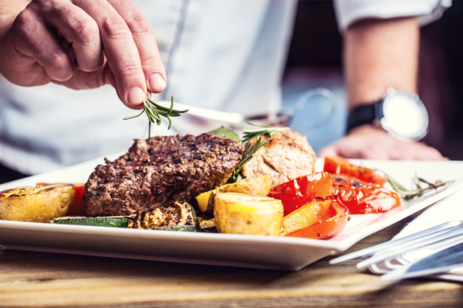 Chef cooking steak. 